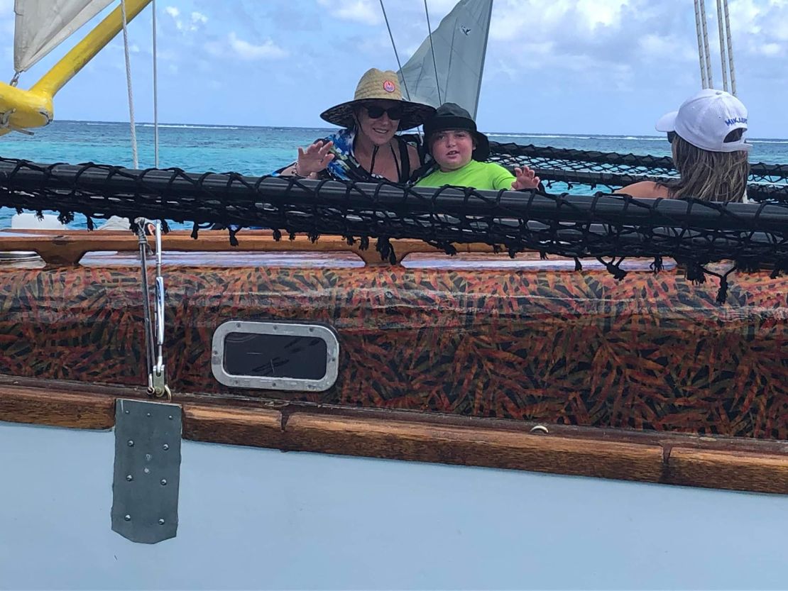 Mathias Pascal and his mother, Aline, enjoy a ride on a traditional boat in Moorea, French Polynesia.