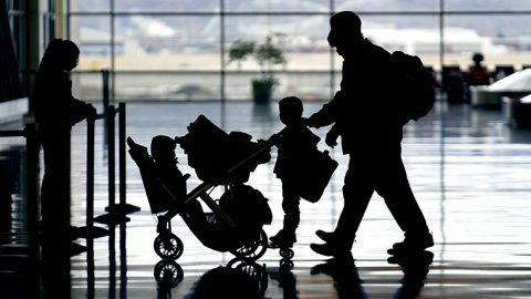 Travelers pass through Salt Lake City International Airport on Friday, Dec. 24, 2021.