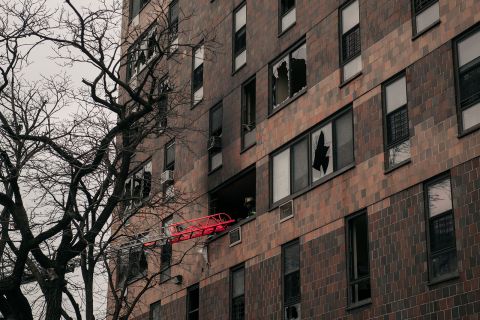 Broken windows and charred bricks mark the exterior of a 19-story residential building after a fire erupted in the morning on January 9, in the Bronx borough of New York City. (Scott Heins/Getty Images)