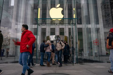 Customers flow through the entrance of an Apple store in New York on November 26.