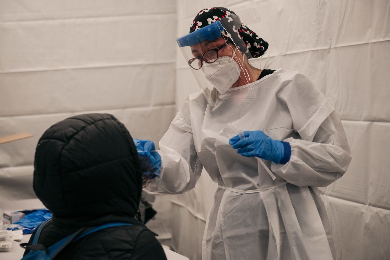 A medical worker administers a COVID-19 test at a new testing site inside the Times Square subway station on December 27, 2021 in New York City. After a week of record-breaking positive COVID test rates, New York City officials and agencies are working to ramp up testing accessibility and turnaround times. 