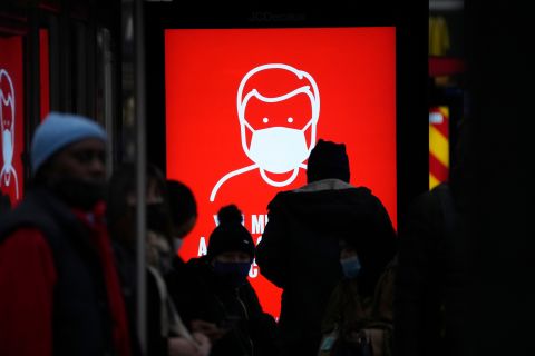 A government digital poster encouraging people to wear face masks to curb the spread of coronavirus is displayed in a bus stop in London on December 17.