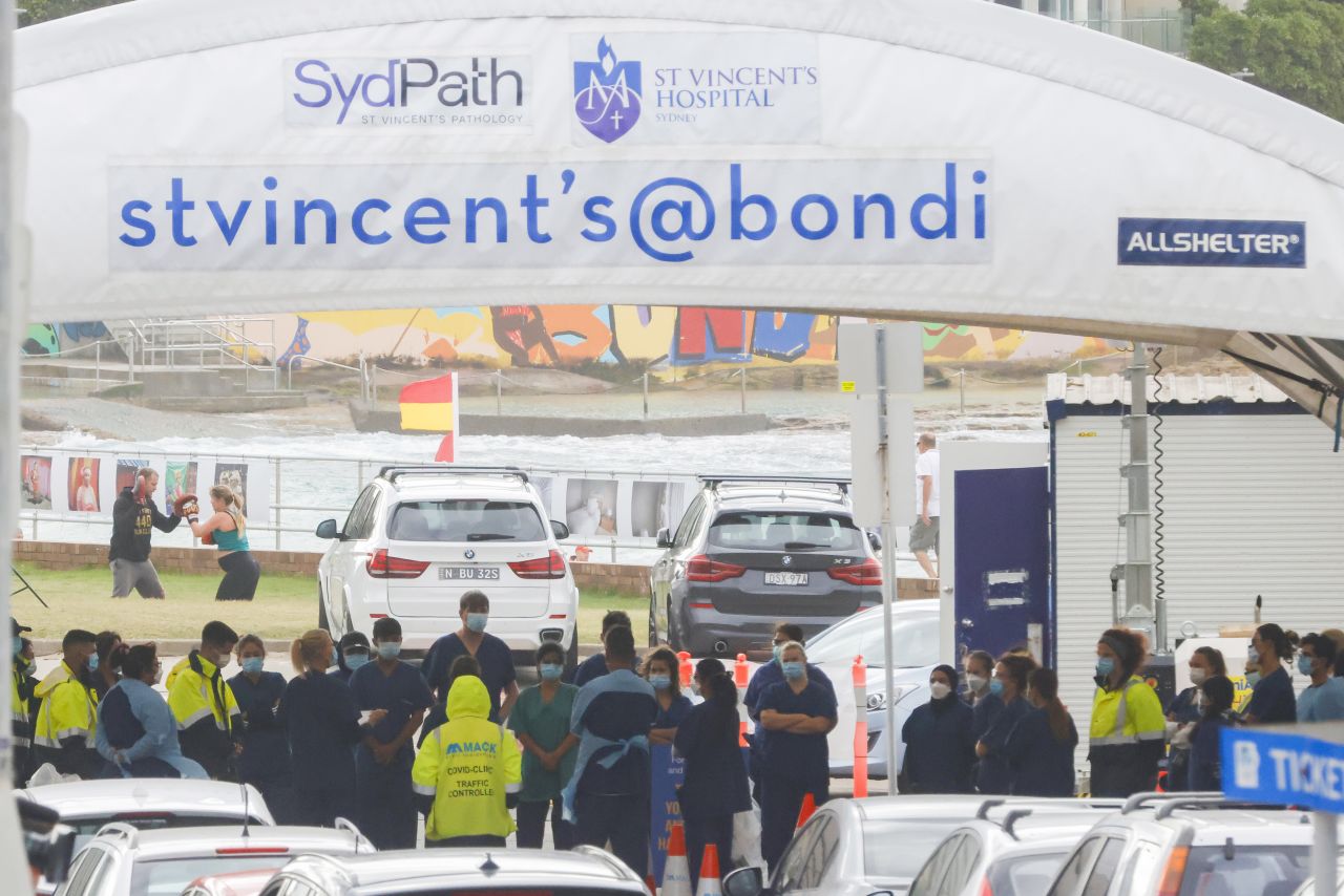 Health workers congregate ahead of the opening of the SydPath COVID-19 testing clinic at Bondi Beach on December 28, 2021 in Sydney, Australia. Covid-19 testing clinics are at capacity in Sydney with increased demand and centres closing for public holidays. 