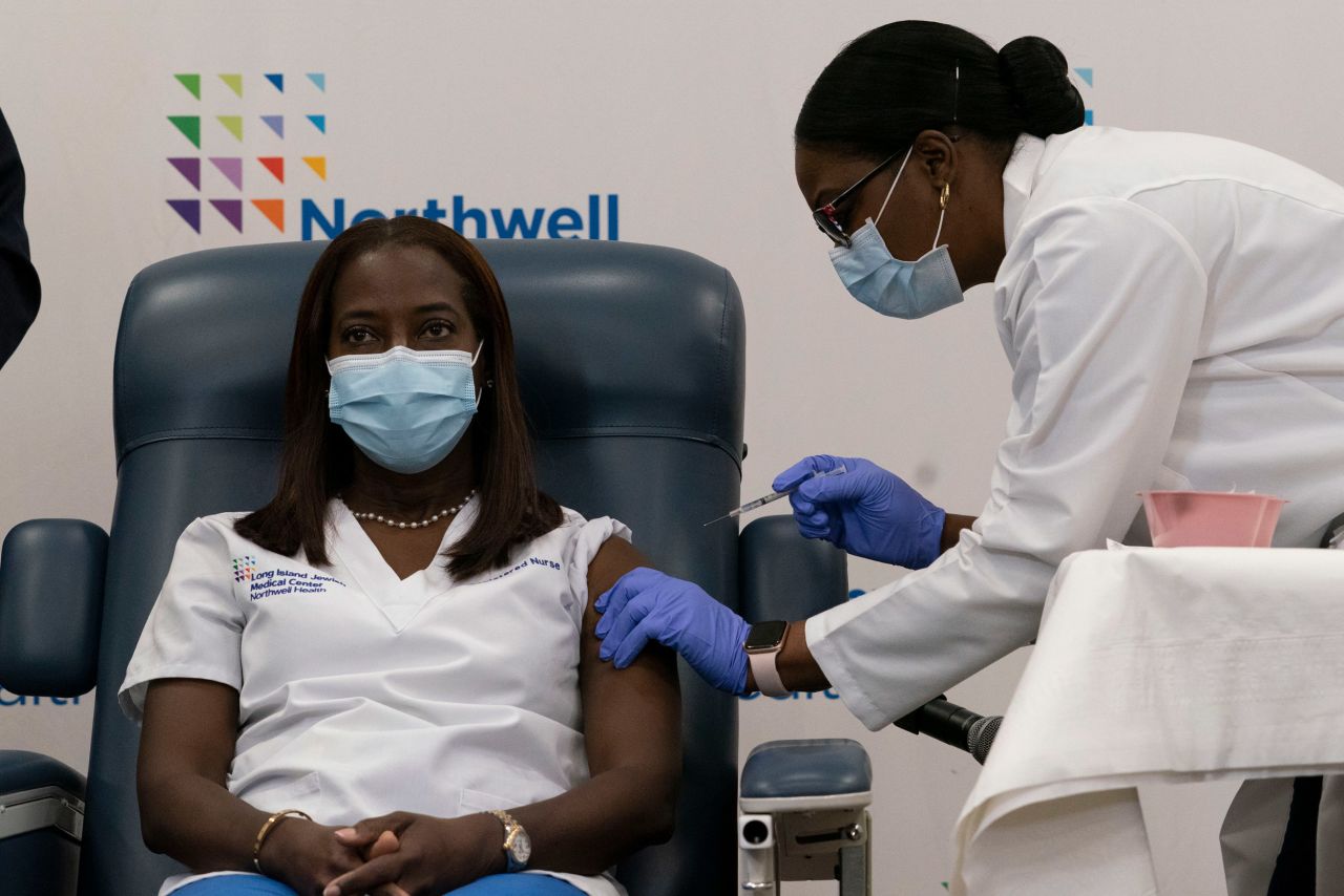 Sandra Lindsay, left, a nurse at Long Island Jewish Medical Center, is inoculated with the Covid-19 vaccine by Dr. Michelle Chester on December 14, 2020, in the Queens borough of New York City. 