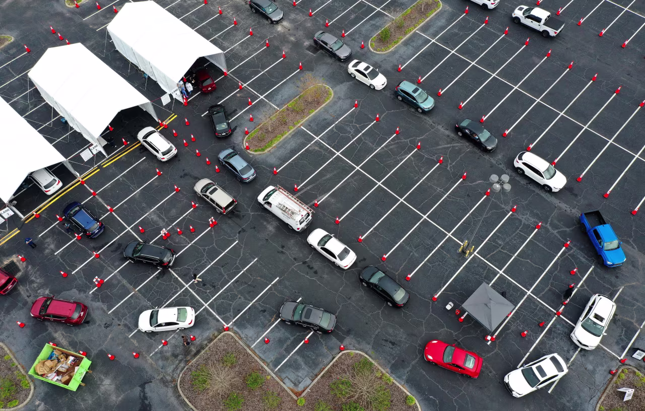 Cars line up at a COVID-19 testing site at the South Orange Youth Sports Complex on December 30, 2021, in Orlando.