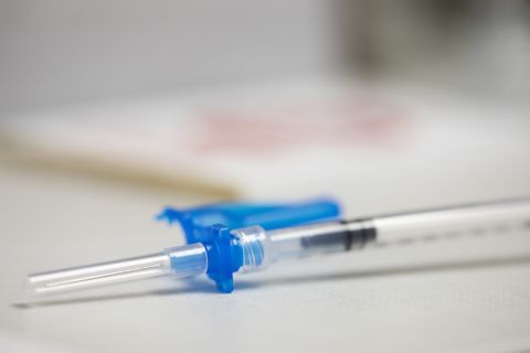 A syringe is prepped for a Moderna COVID-19 booster vaccine at a pharmacy in Portland, Ore., Monday, Dec. 27.