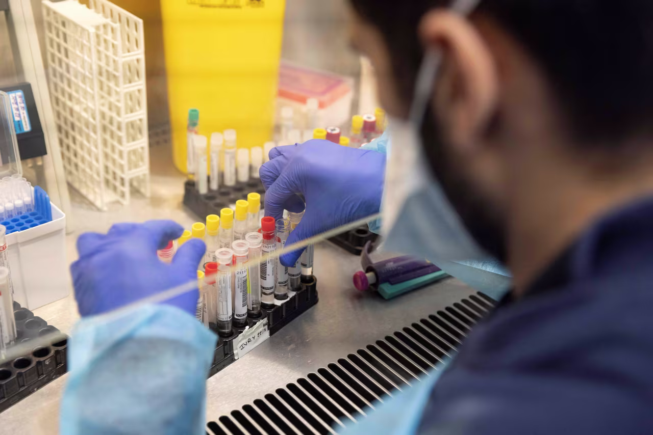 Laboratory operator handles positive Covid-19 samples to be sequenced in the virology laboratory of the AP-HP Henri Mondor Hospital in Creteil, on the outskirt of Paris on December 7, 2021. 