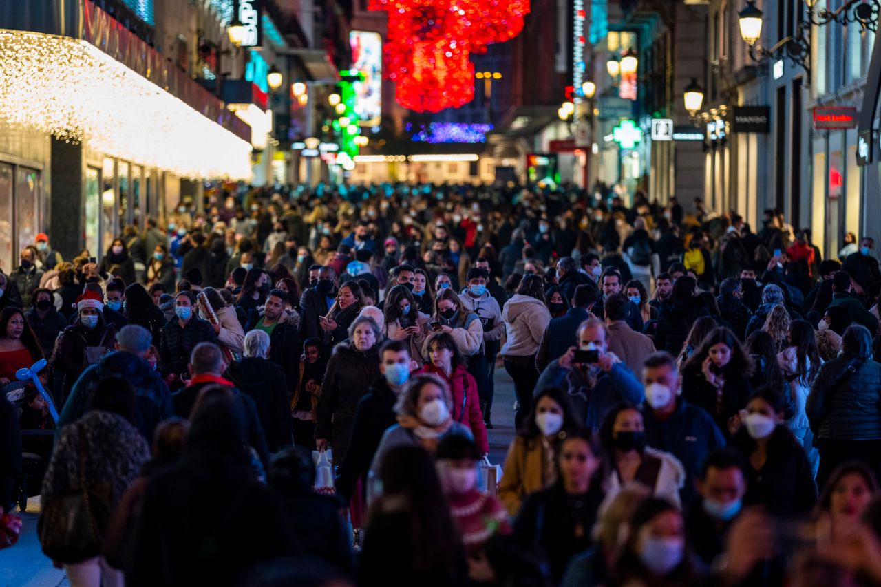 People walk in downtown Madrid on December 21.