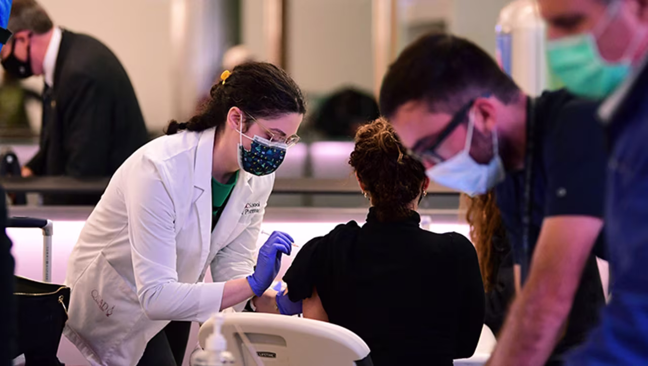 A woman receives her Covid-19 vaccination at a pop-up clinic in the international arrivals area of Los Angeles International Airport in Los Angeles, California, on December 22, 2021. 