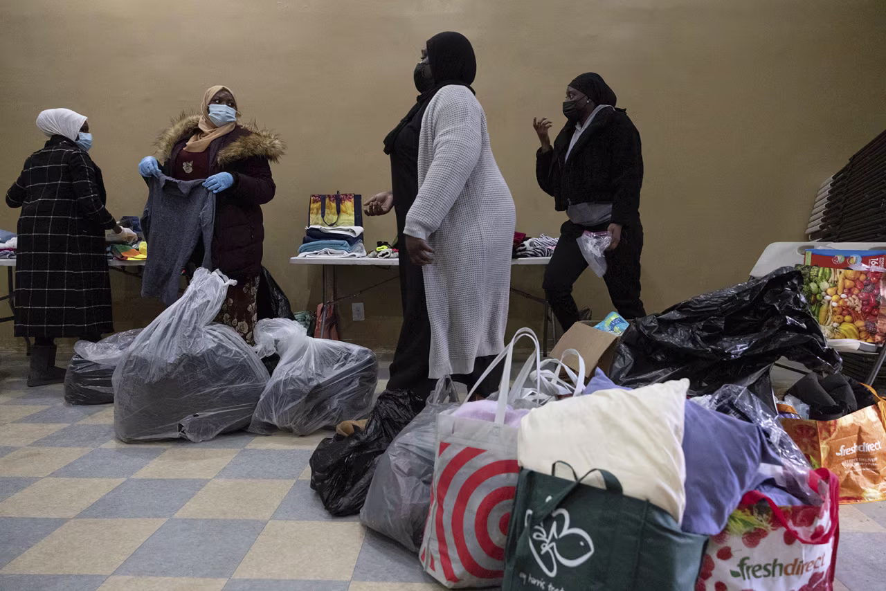 People prepares donations at Gambian Youth Organization near the apartment building where a deadly fire occurred in the Bronx, on Monday. 