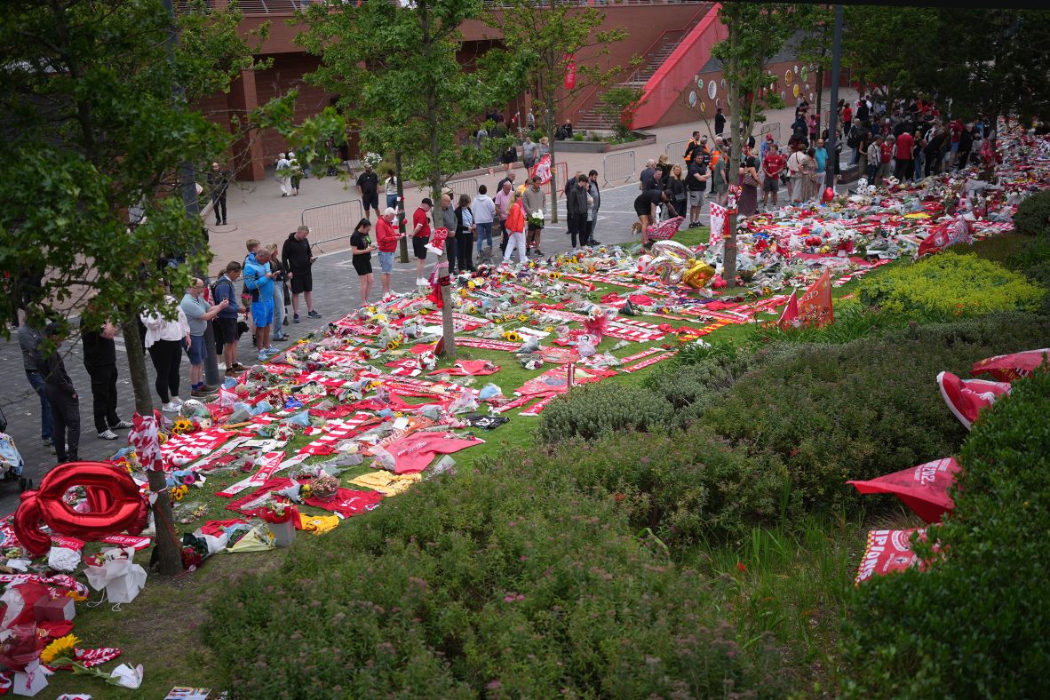 People pay their respects to the late Diogo Jota in Liverpool, England, on Friday.