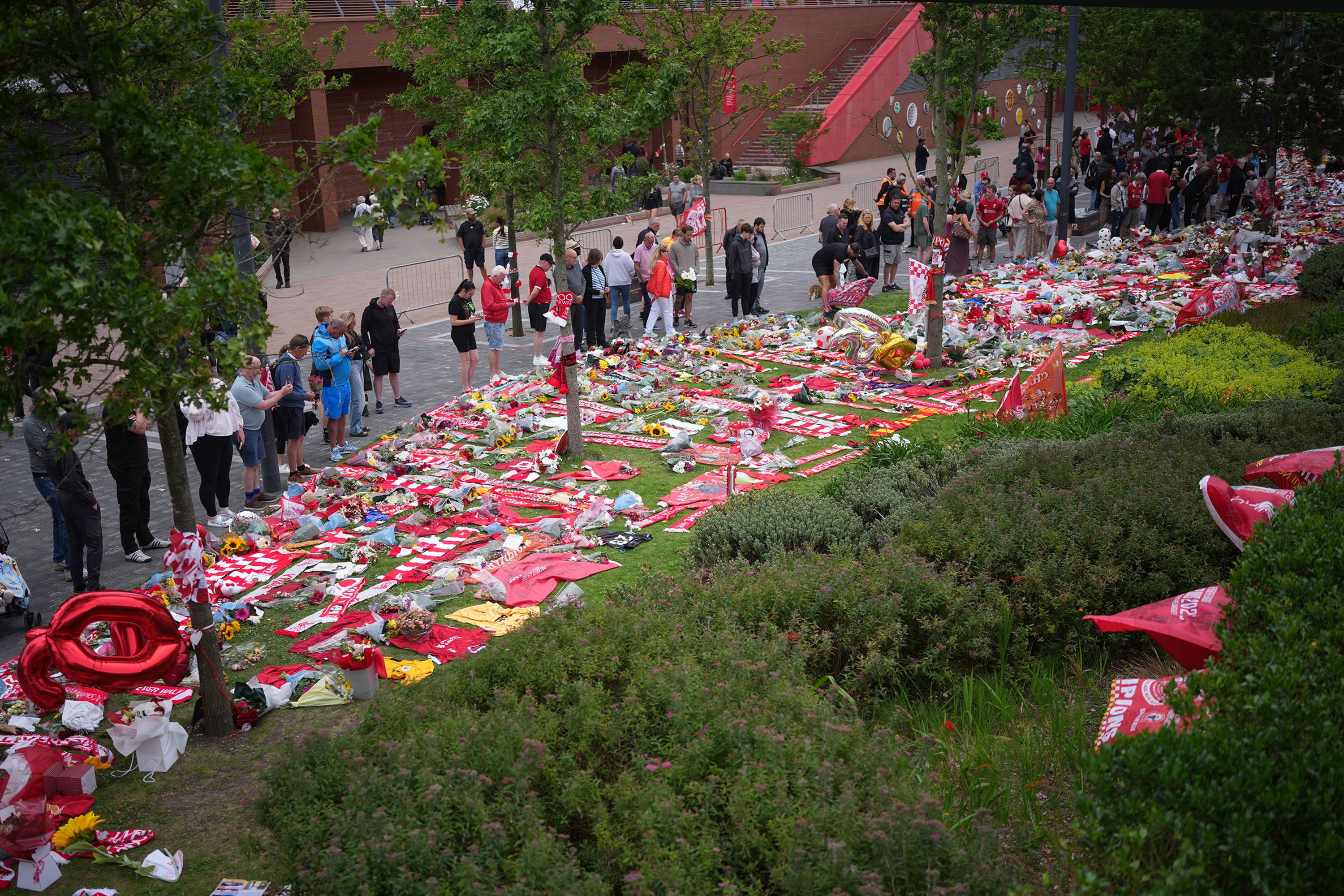 People pay their respects to the late Diogo Jota in Liverpool, England, on Friday, July 4.