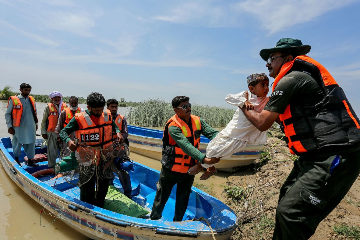 Emergency workers rescue a child from a flooded village following heavy rains in the Taunsa district of Pakistan's Punjab province on July 16.