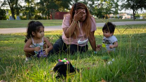 Samantha Casiano cries while visiting the gravesite of her daughter Halo with her daughter Camila and son Louie.