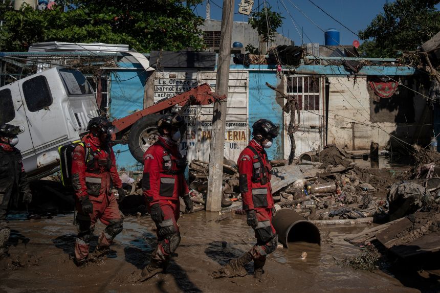 Rescue workers patrol a street in Poza Rica, Veracruz state, Mexico, on Sunday, Oct. 12, 2025, after widespread flooding.