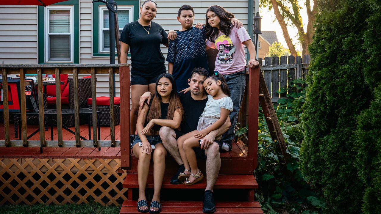 From left, Fantazia Lor, Azia Yang, Michael Bub III, Michael Bub Jr., Mila Bub and Baylee Bub sit for a portrait during a family barbecue at Bub Jr.'s parents' home in West Milwaukee, Wisconsin, on July 15.