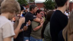 A couple embraces during a vigil for the Apalachee High School shooting at Jug Tavern Park in Winder, Georgia, on September 4, 2024, after a shooting took place. A 14-year-old gunman killed at least four people, including two students, and wounded nine more when he opened fire at a high school in the US state of Georgia on September 4, law enforcement said.
The shooter -- also a student at the school -- was taken into custody. He will be charged with murder and tried as an adult, the Georgia Bureau of Investigation said. 
Two teachers were also among the dead. (Photo by CHRISTIAN MONTERROSA / AFP) (Photo by CHRISTIAN MONTERROSA/AFP via Getty Images)