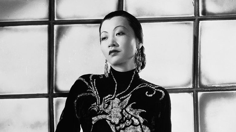 Anna May Wong wears a dress with a dragon motif in 1934. 