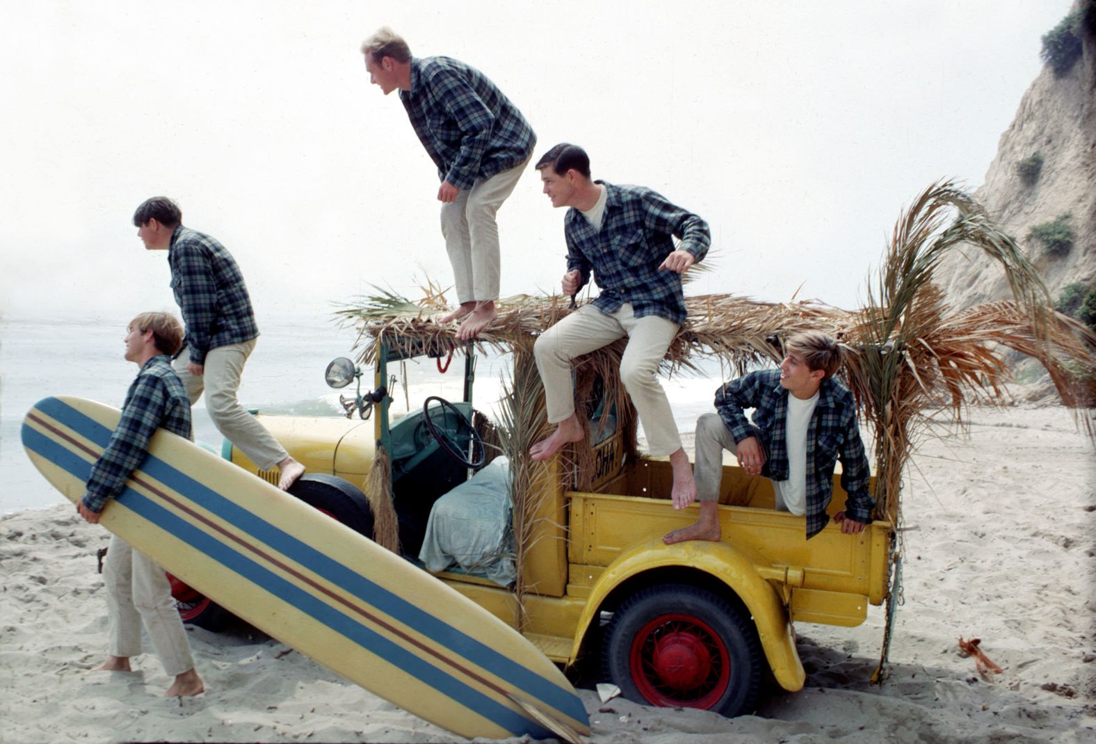 The Beach Boys pose for a portrait with a vintage station wagon in Los Angeles in 1962. From left are Dennis Wilson, Carl Wilson, Mike Love, Brian Wilson and David Marks. Carl, Dennis and Brian were brothers.