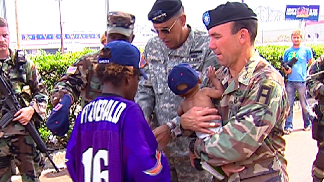 Honoré, center, helps Alexandria Wheeler and her twins after Hurricane Katrina in 2005 in New Orleans.