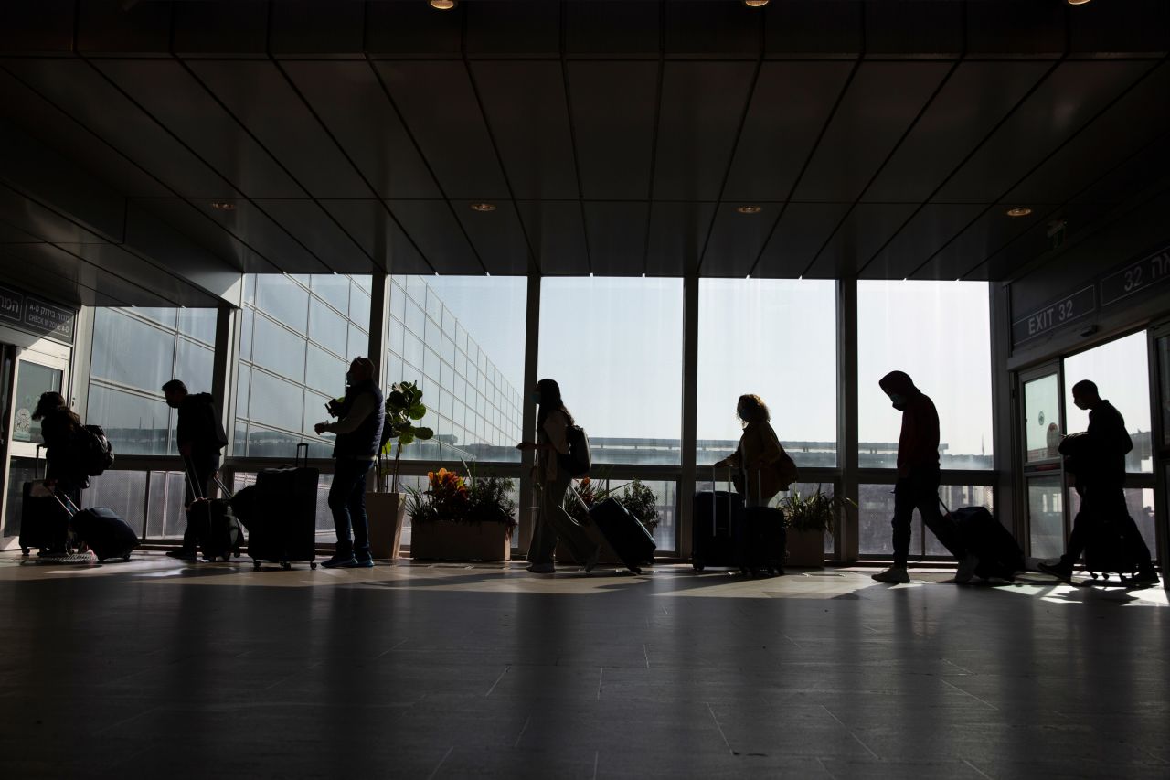 Travelers walk with their luggage in the Ben Gurion Airport near Tel Aviv, Israel, on November 28.