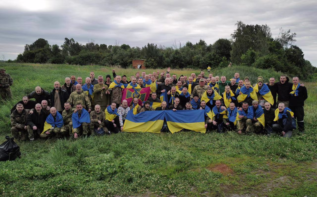 Ukrainian prisoners of war pose for a picture after a swap at an unknown location in Ukraine, in this handout picture released on June 11.