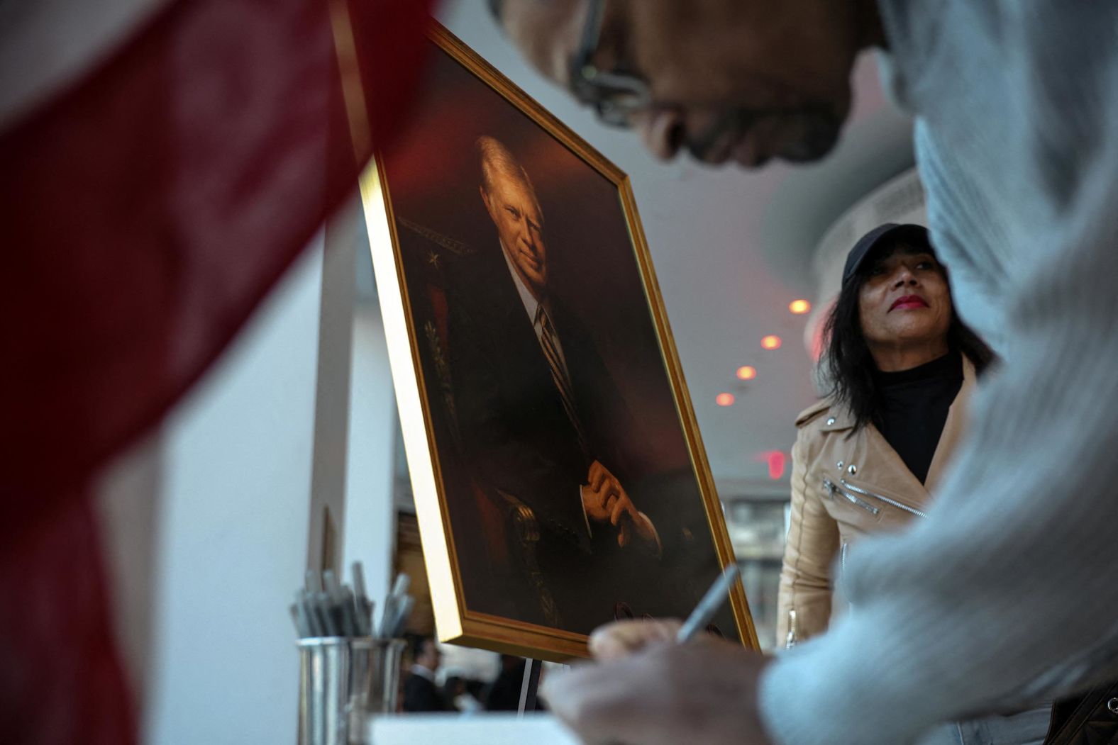 Visitors to "The People’s House: A White House Experience" sign a condolence book for the late US President Jimmy Carter in Washington, DC, on December 30, 2024.