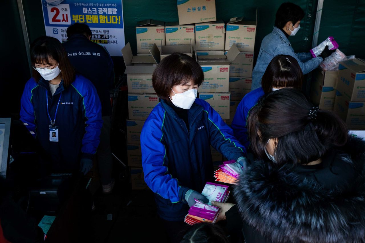 People buy protective masks at a supermarket in Seoul, South Korea, on March 5.