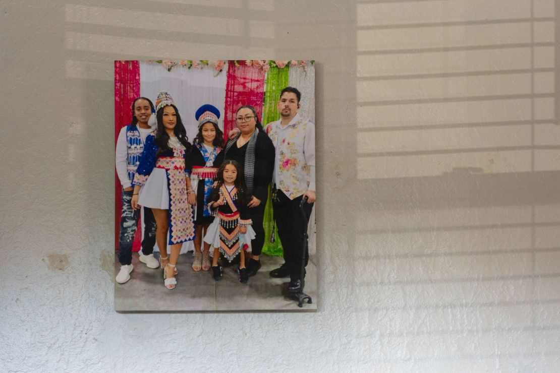 A family portrait of Ma Yang and Michael Bub Jr.’s family hangs on the wall of his parents’ living room in West Milwaukee.