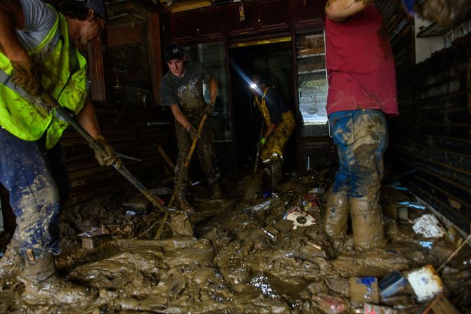 Friends help Sam Soughail, third from left, clear out his Casablanca Cigar Bar in Asheville, North Carolina, on Tuesday, October 1.