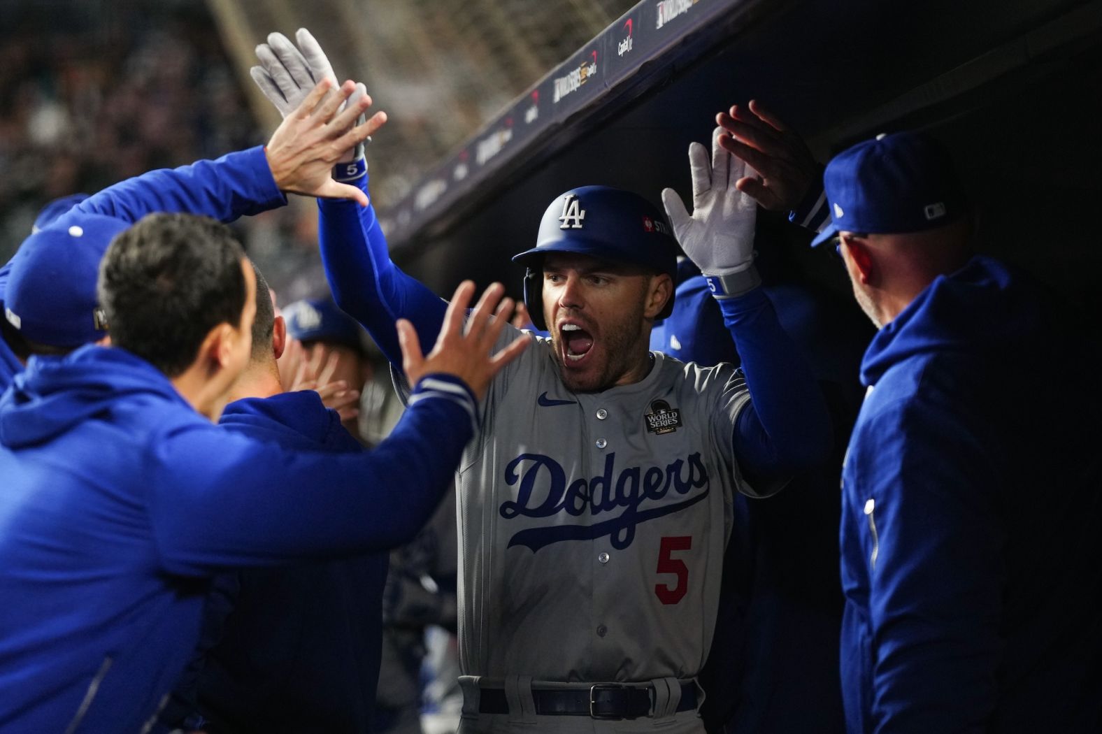 Freeman celebrates in the dugout after hitting a two-run home run in the first inning on Monday.