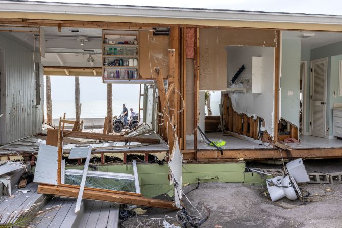 A rescue team checks a damaged property on Manasota Key on Friday.