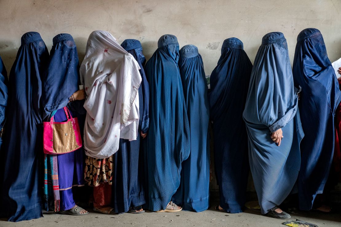 Afghan women wait to receive food rations distributed by a humanitarian aid group, in Kabul, Afghanistan, May 23, 2023.