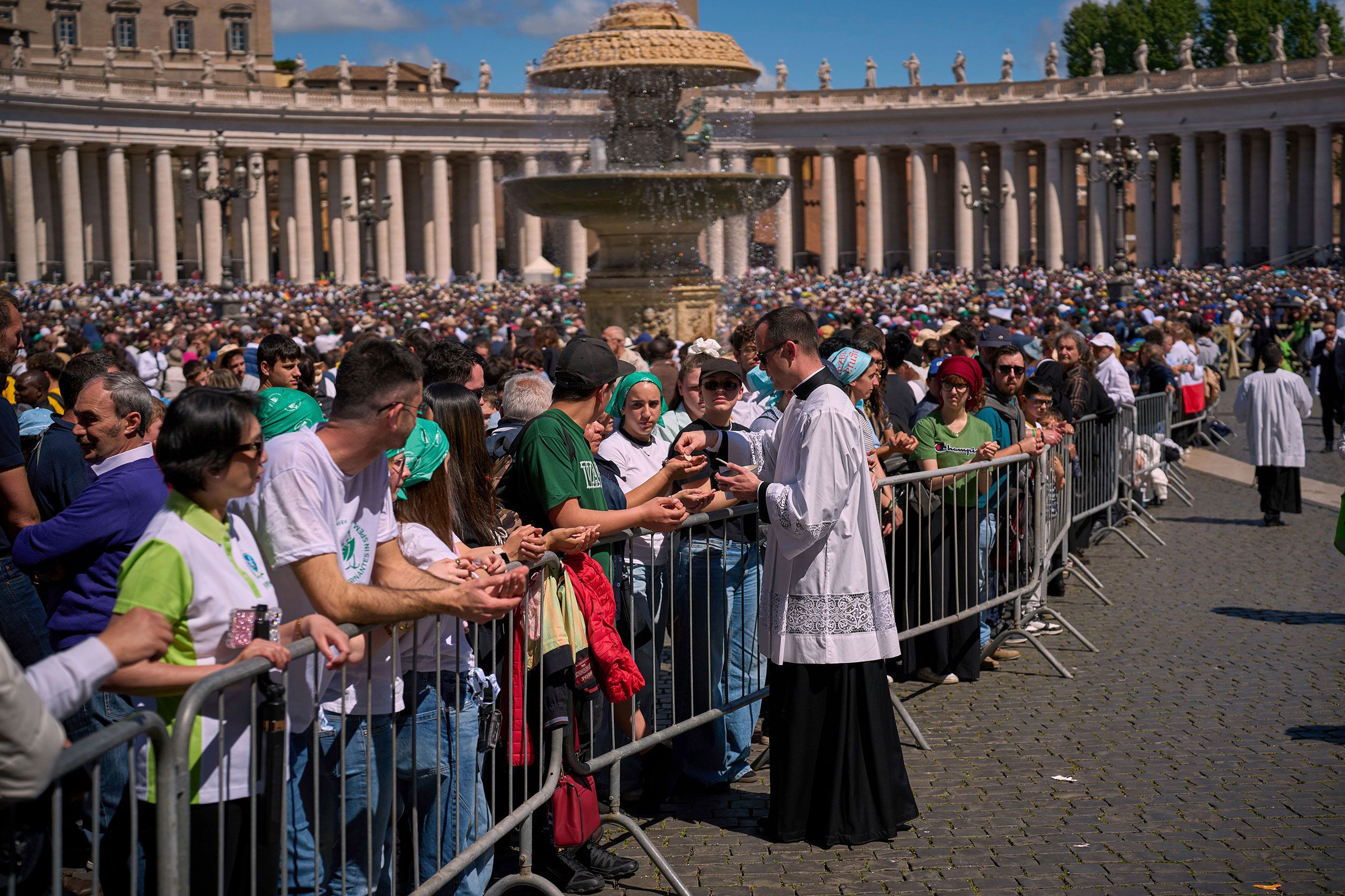 Mourners receive communion during the funeral on Saturday.