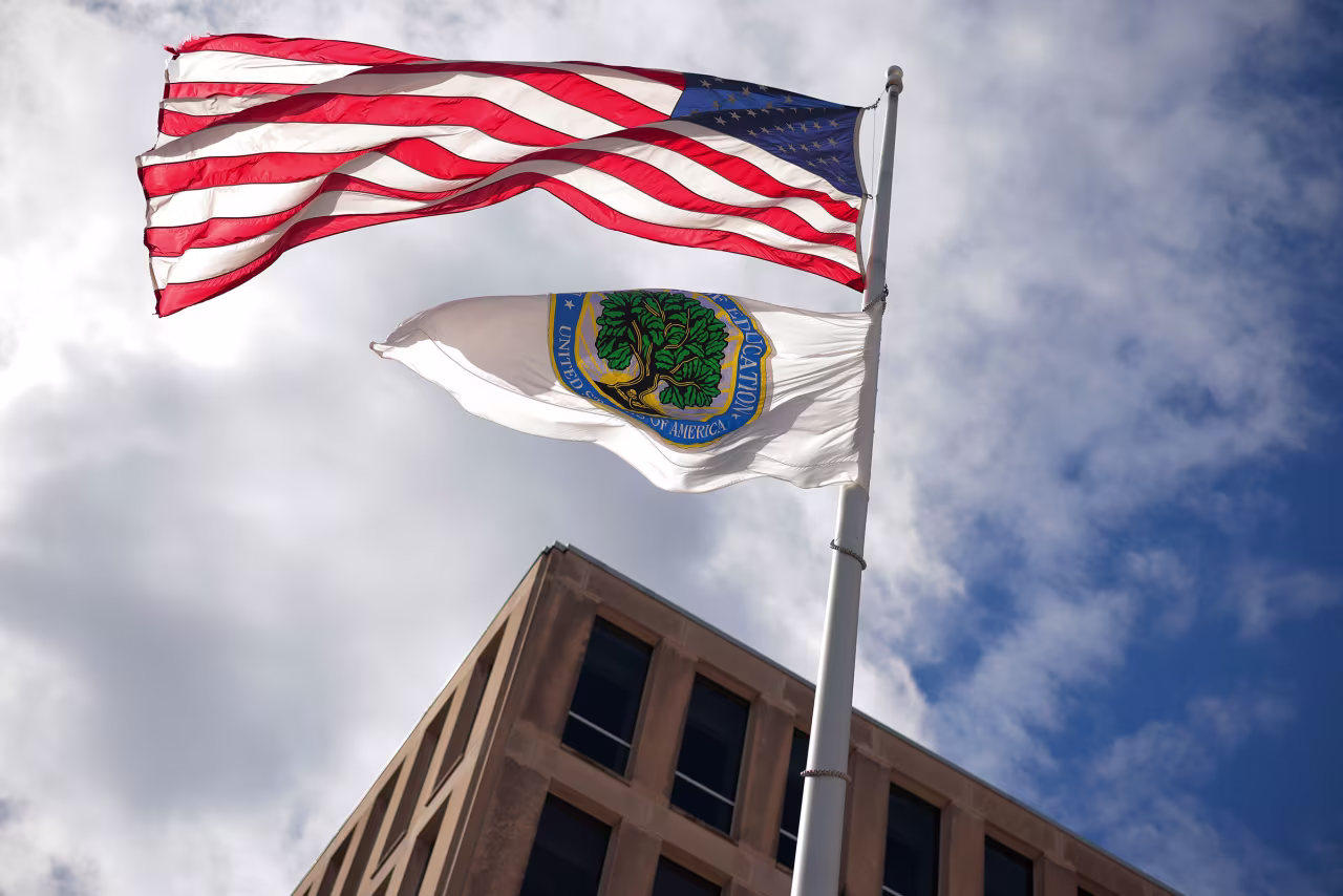 An American flag and Department of Education flag whip in the wind outside the department's headquarters in Washington, DC, on March 6.