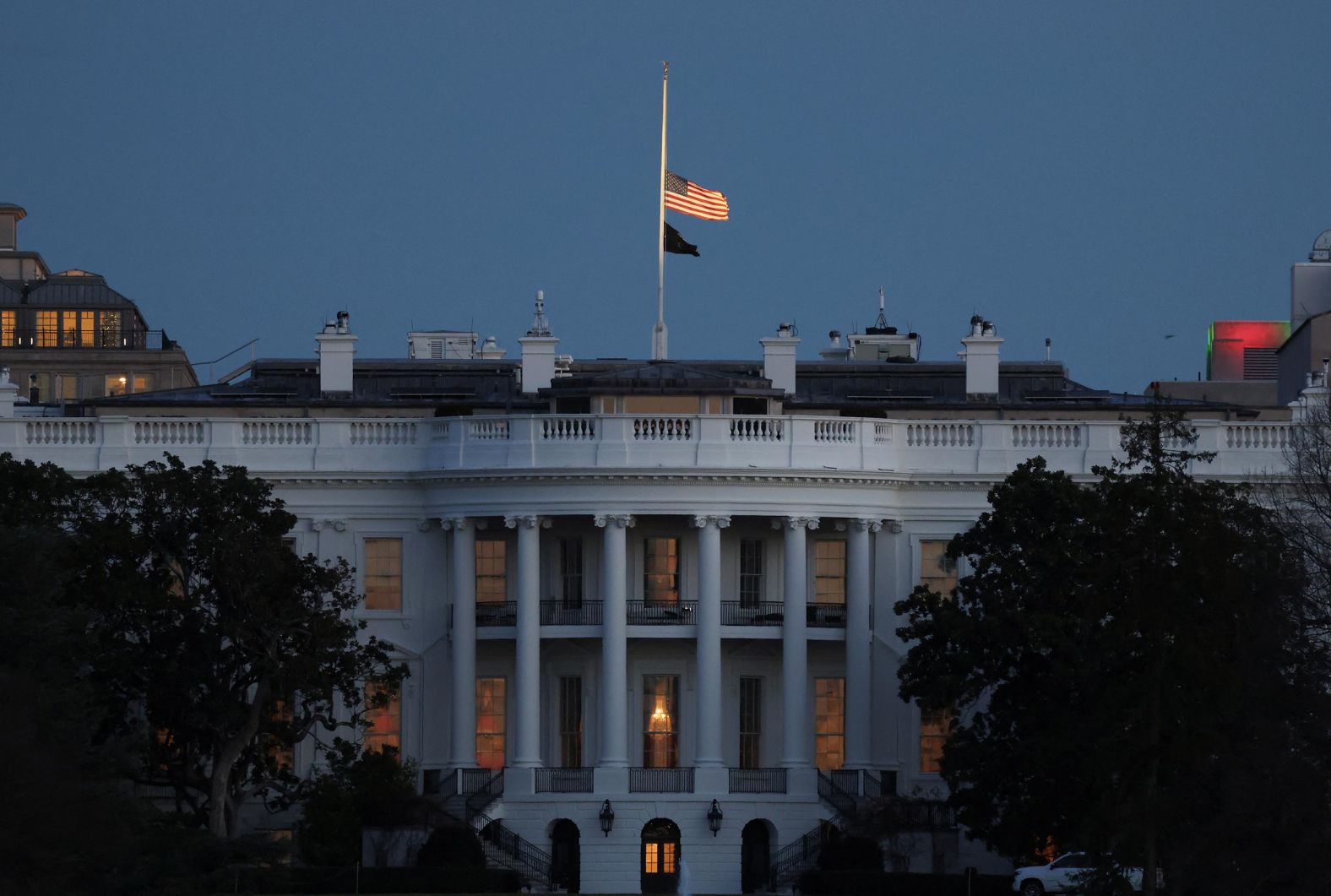 The flag over the White House flies at half-staff on December 30.