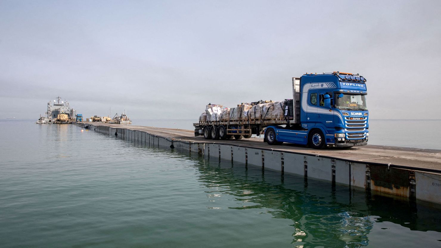 This handout photo shows a truck carrying humanitarian aid across Trident Pier off the Gaza Strip on May 19.