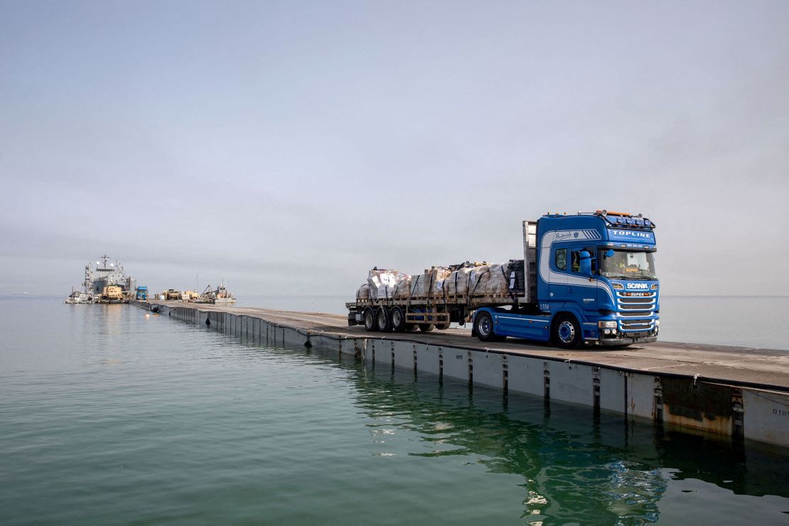 This handout photo shows a truck carrying humanitarian aid across Trident Pier off the Gaza Strip on May 19.