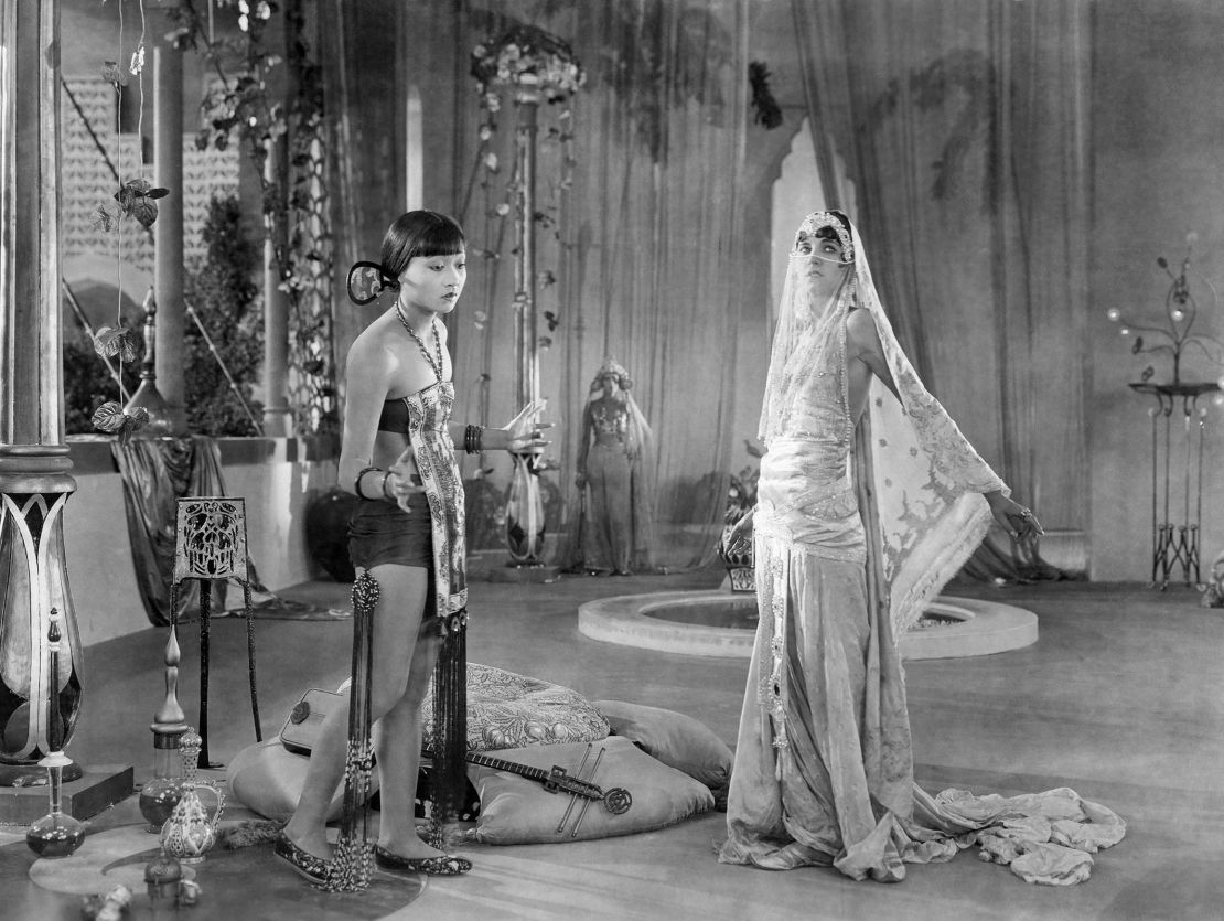 Anna May Wong and Julanne Johnston on set during the filming of "The Thief of Baghdad."