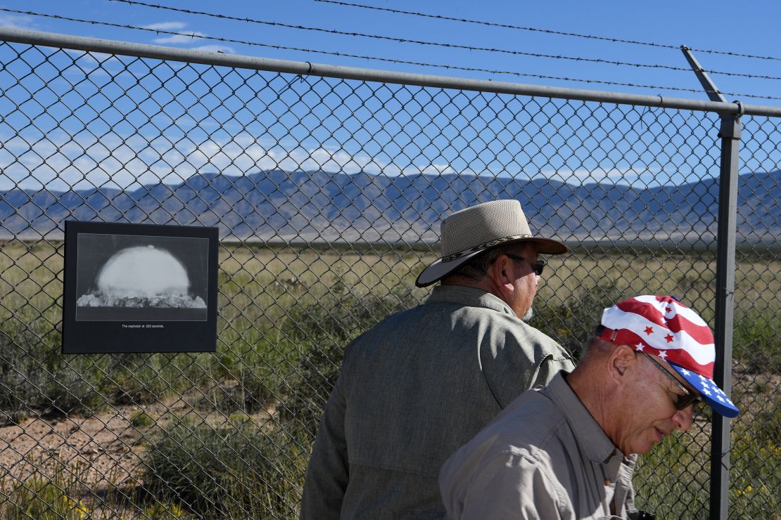 A photograph hangs on a fence at the Trinity Site — the location of the world's first atomic bomb detonation — at White Sands Missile Range in New Mexico.