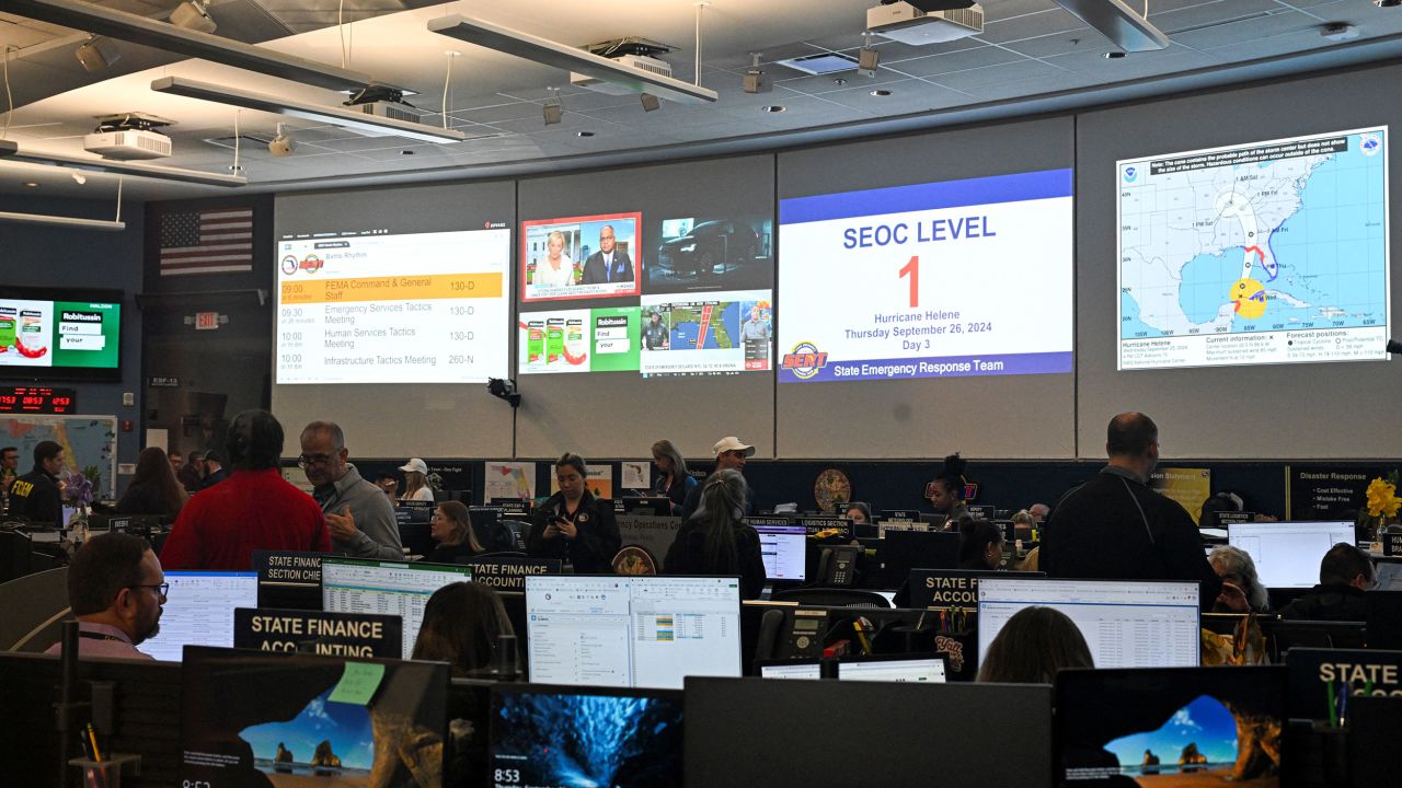 People work at the State Emergency Operations Center in Tallahassee, Florida, on Thursday.