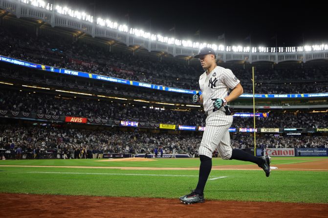 Stanton runs onto the field before Game 3.