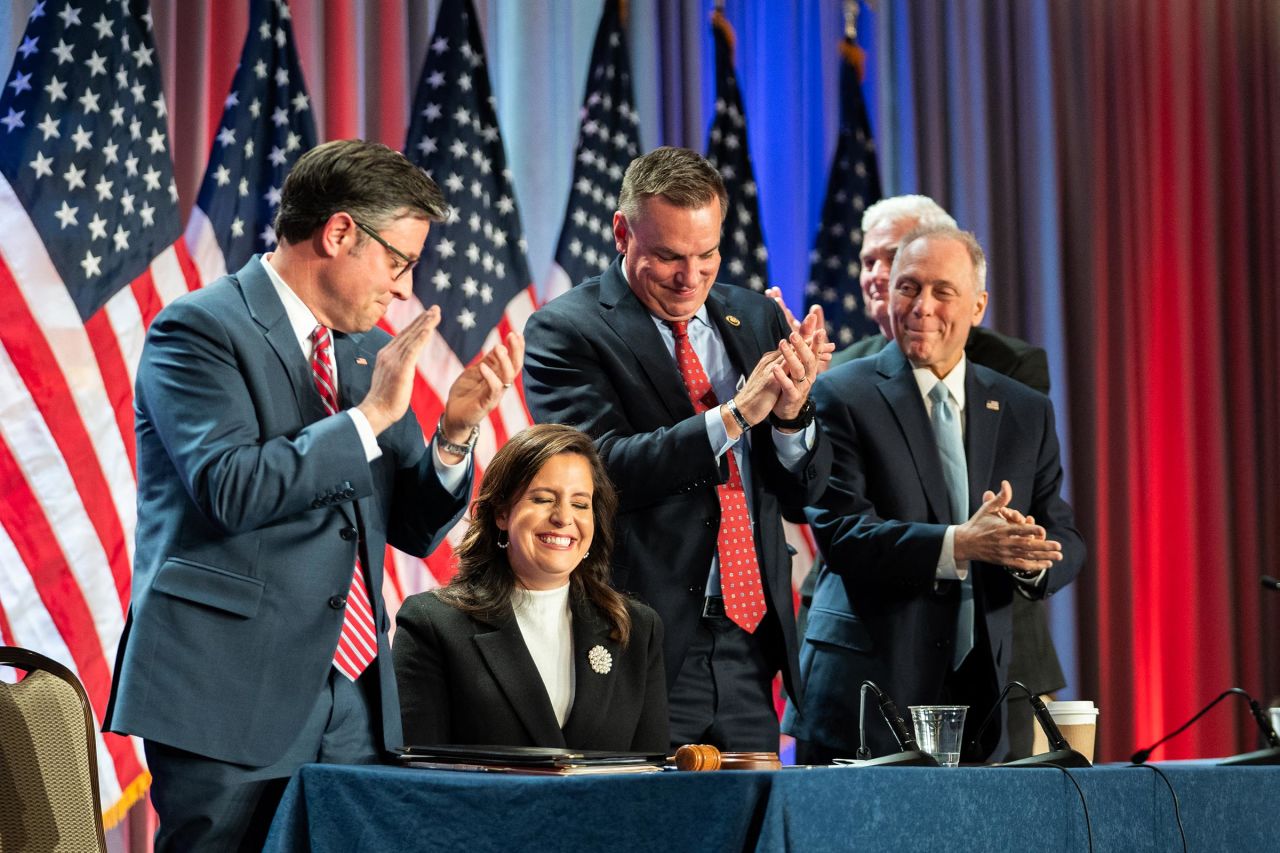 House Speaker Mike Johnson (L) applauds Representative Elise Stefanik, who has been nominated by President-elect Donald Trump to serve as the US ambassador to the United Nations, during a meeting with House Republicans and Trump at the Hyatt Regency hotel in Washington, DC on November 13, 2024.