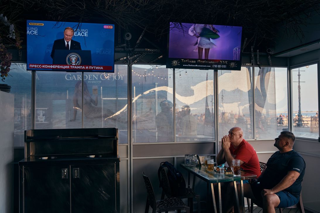 People watch a broadcast of the meeting between Russian President Vladimir Putin and US President Donald Trump, from a restaurant in the Brighton Beach neighborhood of Brooklyn, New York.