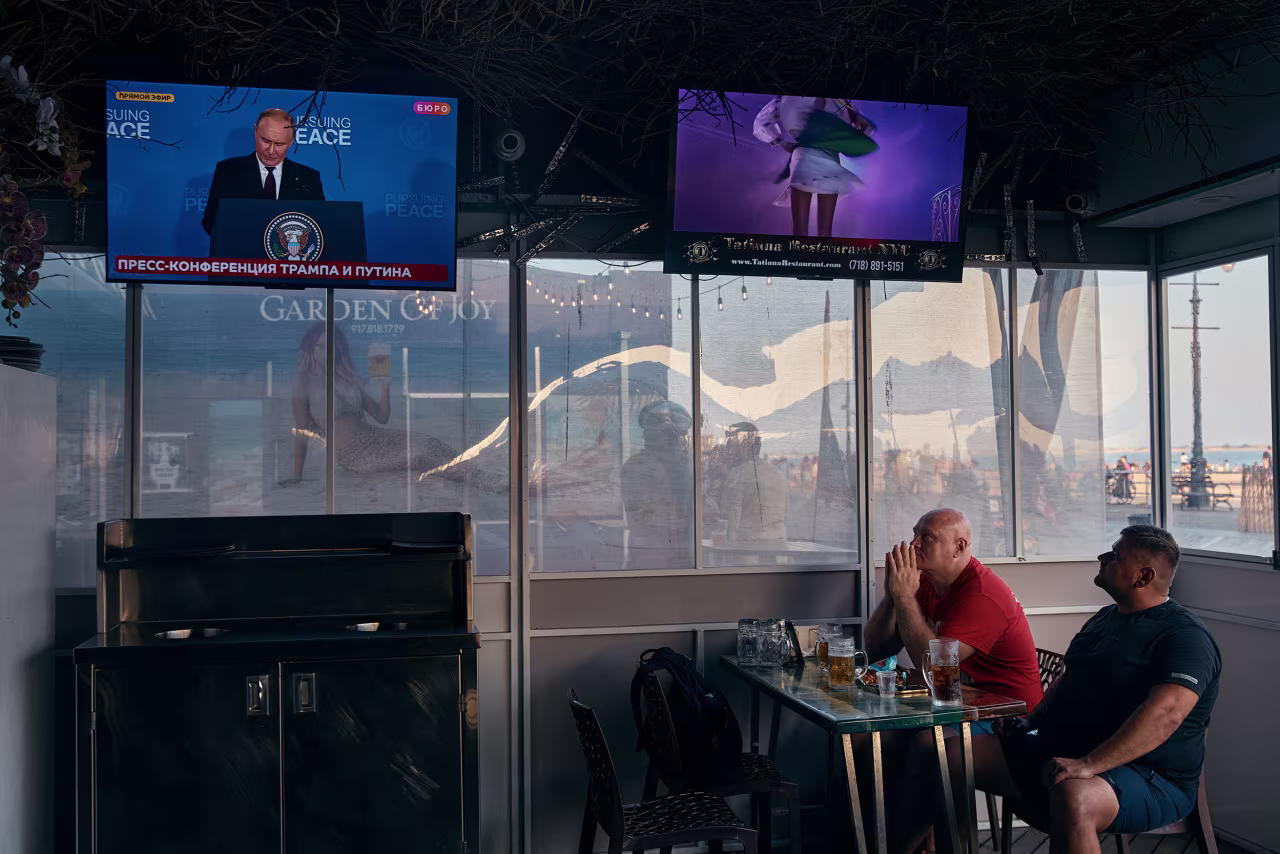 People watch the news conference at Tatiana restaurant in the Brighton Beach neighborhood of Brooklyn, New York.