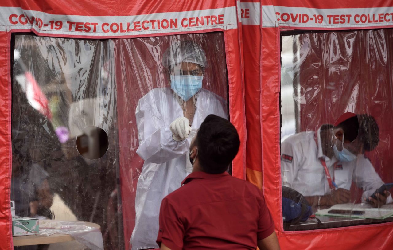 A health care worker collects a swab sample at a Covid-19 testing center in Mumbai, India, on April 22.