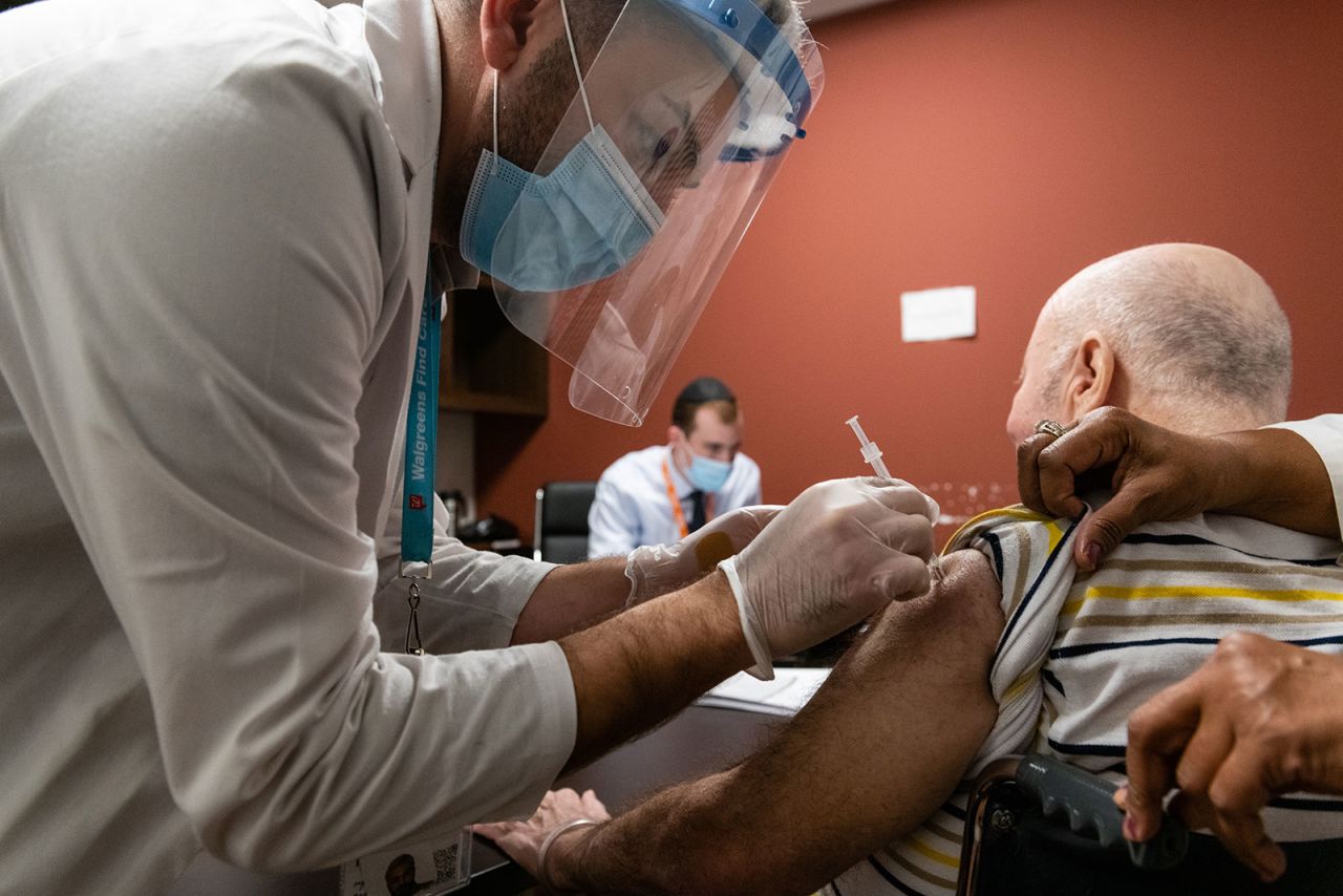 A pharmacist administers a Covid-19 vaccine dose to a nursing home resident in Brooklyn, New York, on January 5.