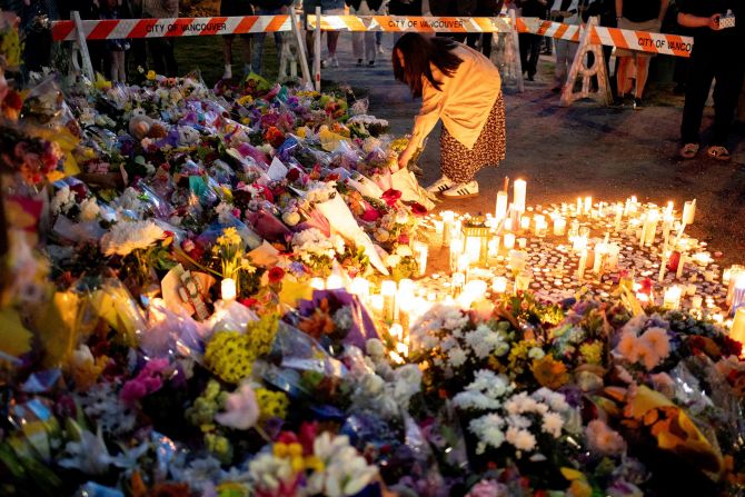A woman leaves flowers in Vancouver, British Columbia, on Sunday, April 27. The night before, <a  target="_top" href="/newspapers?url=https://www.cnn.com/2025/04/27/americas/canada-vancouver-attack-what-we-know-intl-hnk">a car plowed into a crowd</a> at a street festival celebrating Filipino heritage. At least 11 people were killed, and dozens were injured.
