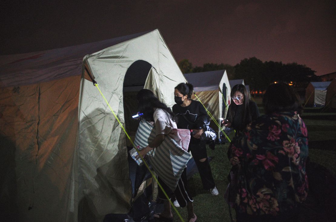 Earthquake affected people enter a tent at a temporary reception center at a local school in Hualien on April 3, 2024.