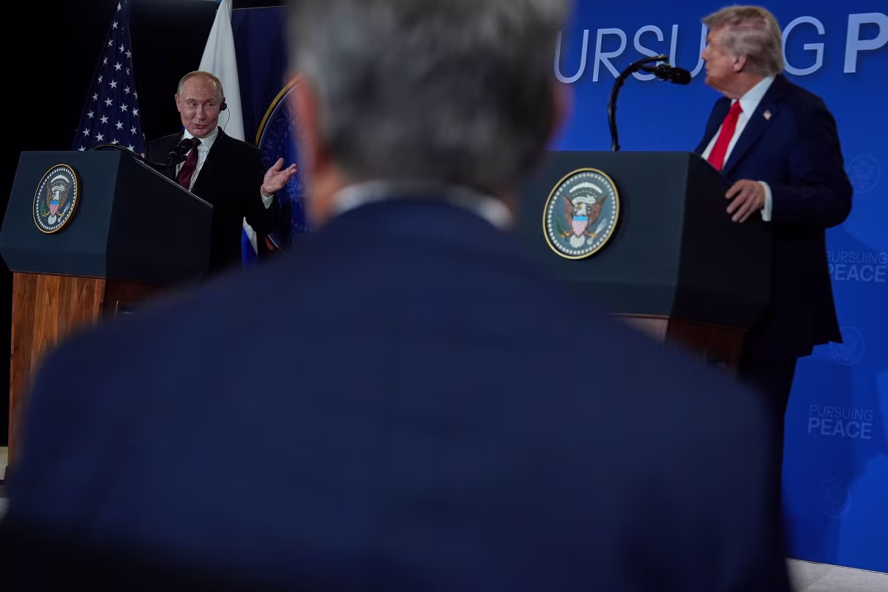 Russian President Vladimir Putin gestures toward US President Donald Trump while speaking at Friday's news conference.